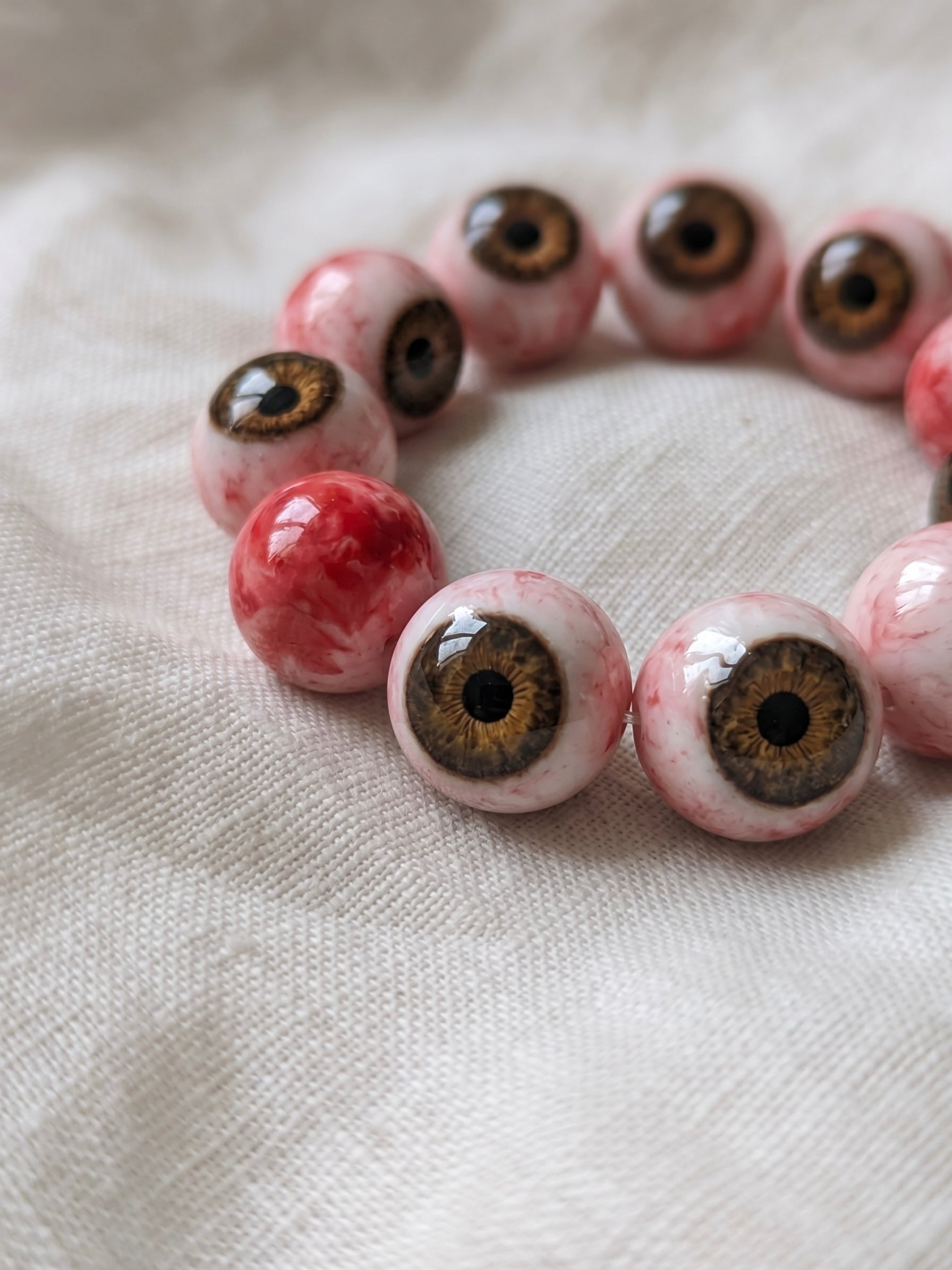 Eye bead bracelet on pale fabric