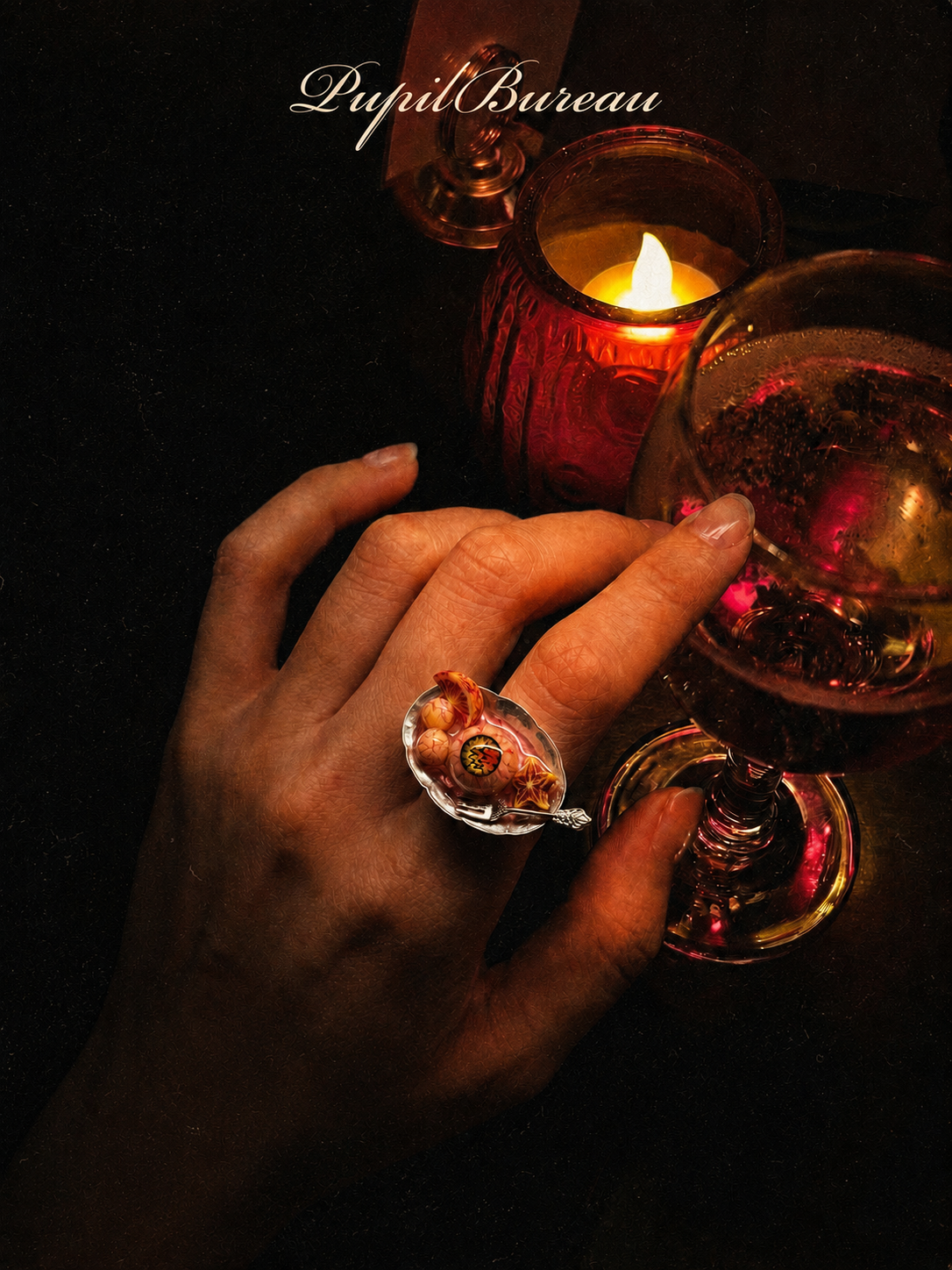Surreal eye jewelry in a candlelit setting