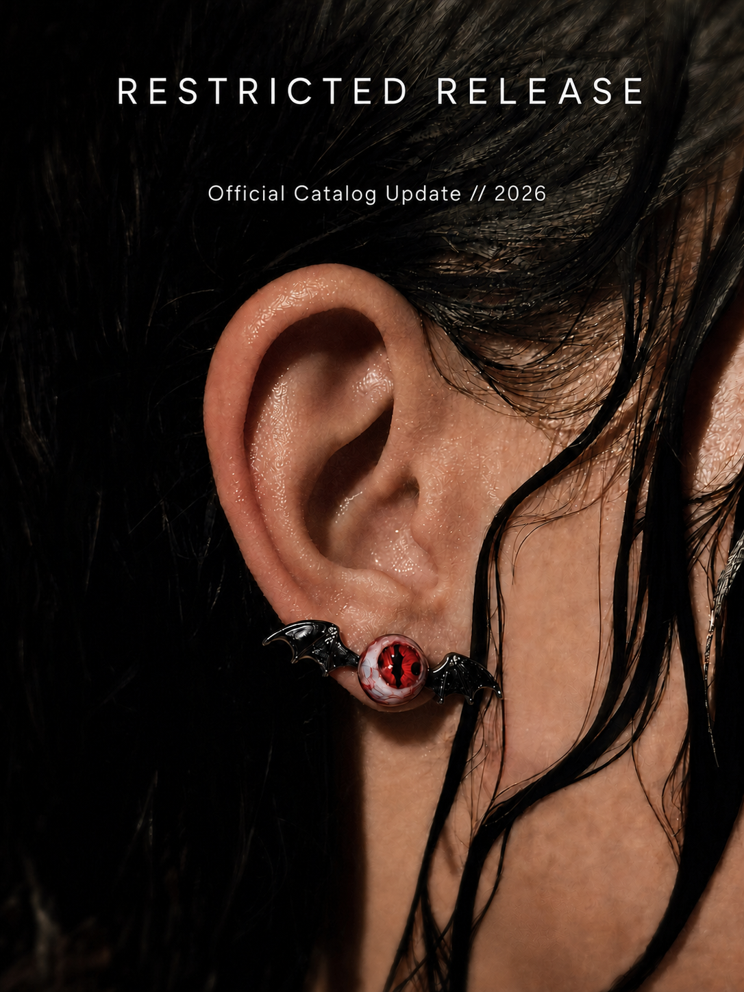 Bat wing eye earring worn on ear